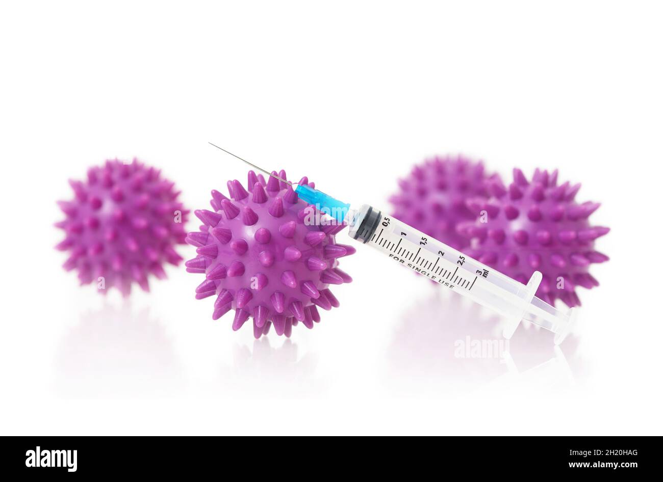 Syringe for injection against the white background with viruses. Stock Photo
