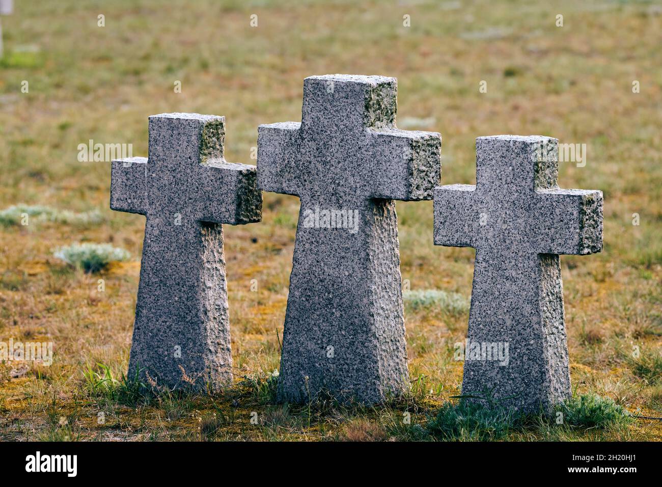 Three catholic stone crosses in German military cemetery in Europe. Memorial for dead soldiers