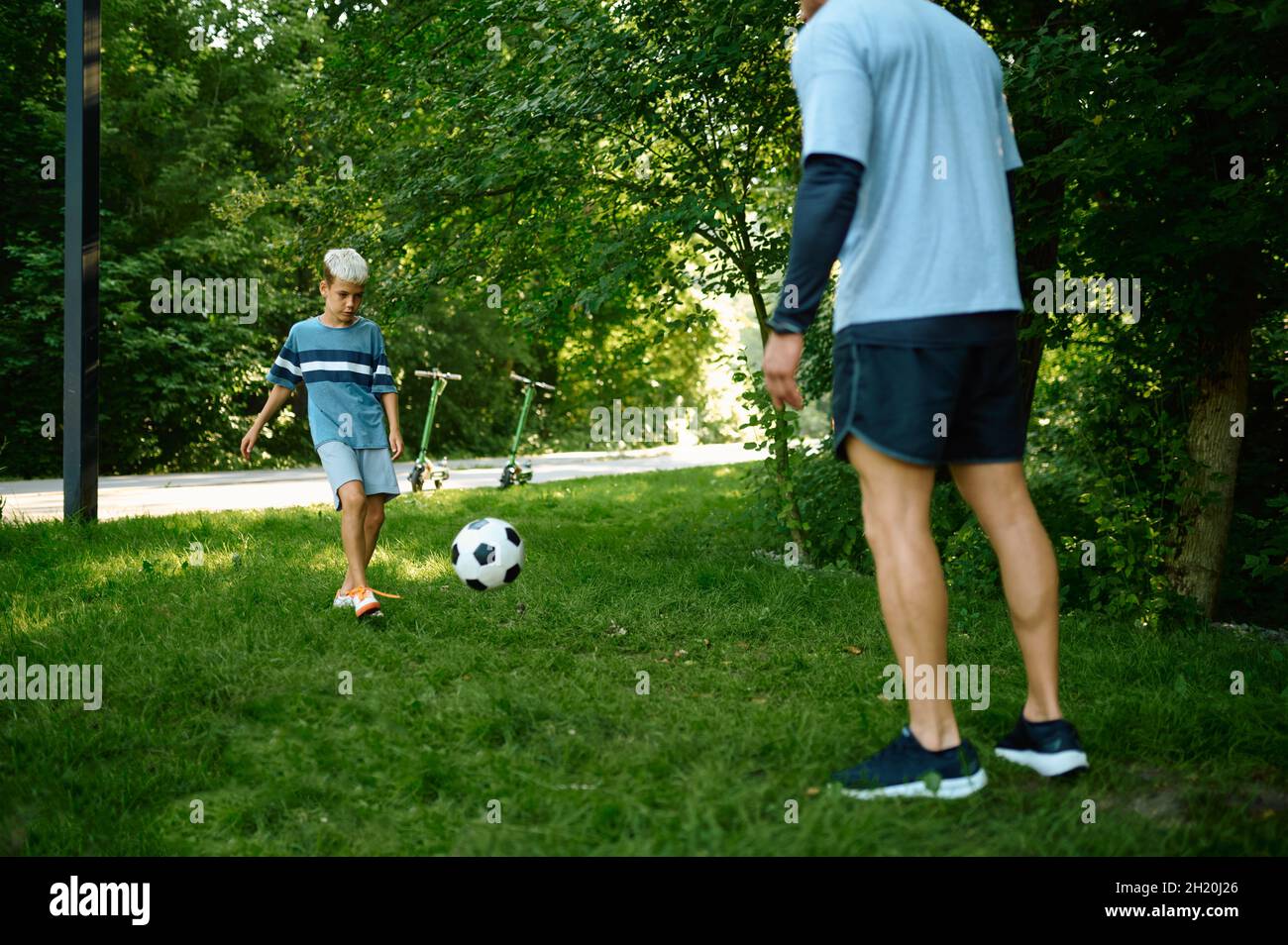 Father and son play football on the grass outdoors Stock Photo - Alamy