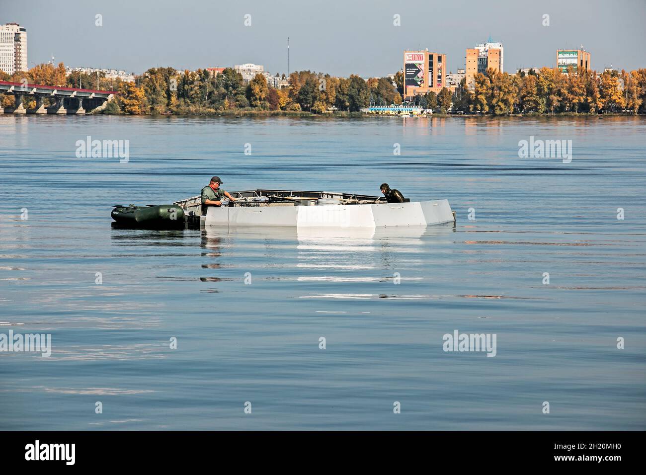 Dnepropetrovsk, Ukraine - 10.15.2021: Maintenance works of the city fountain. Municipal service workers, one in a diving suit and the other on a rubbe Stock Photo