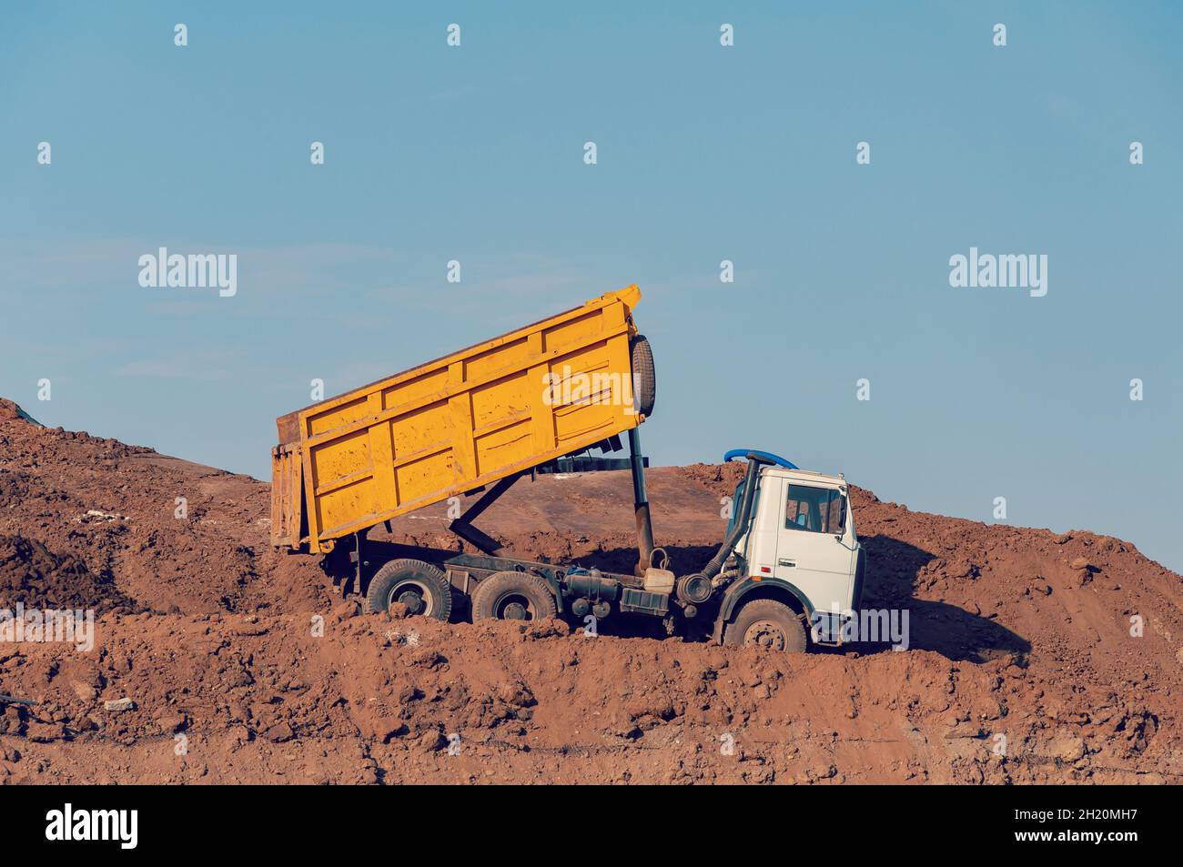 Dump truck is dumping gravel on an excavation site Stock Photo Alamy