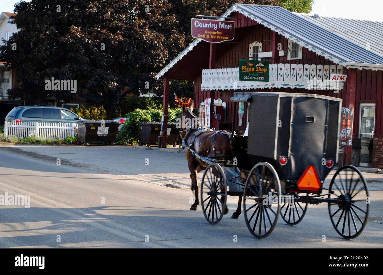 Horse and carridge passing a country store at the Amish country in Ohio,USA Stock Photo