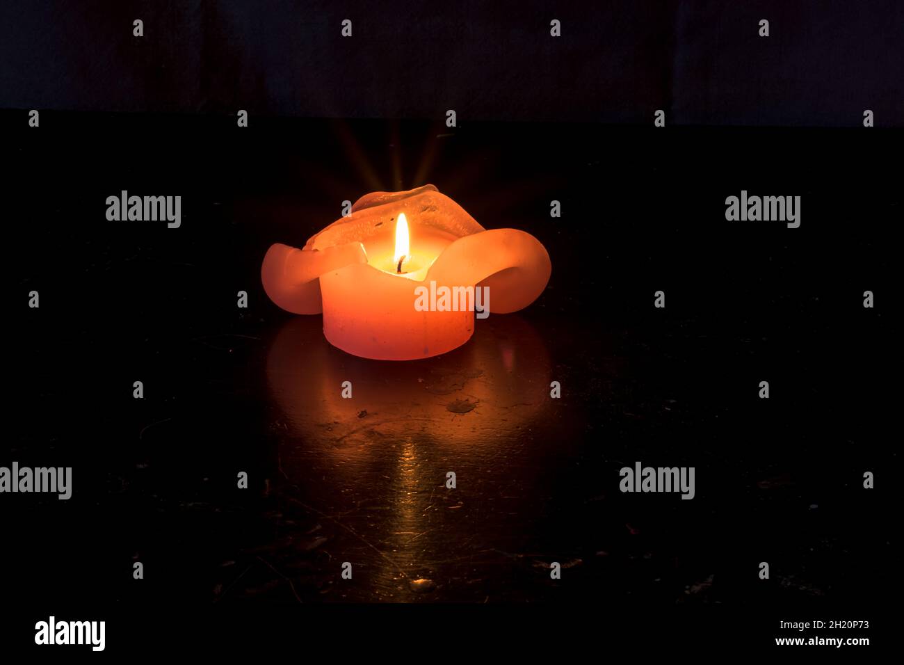 one festive burning candle on black Stock Photo Alamy