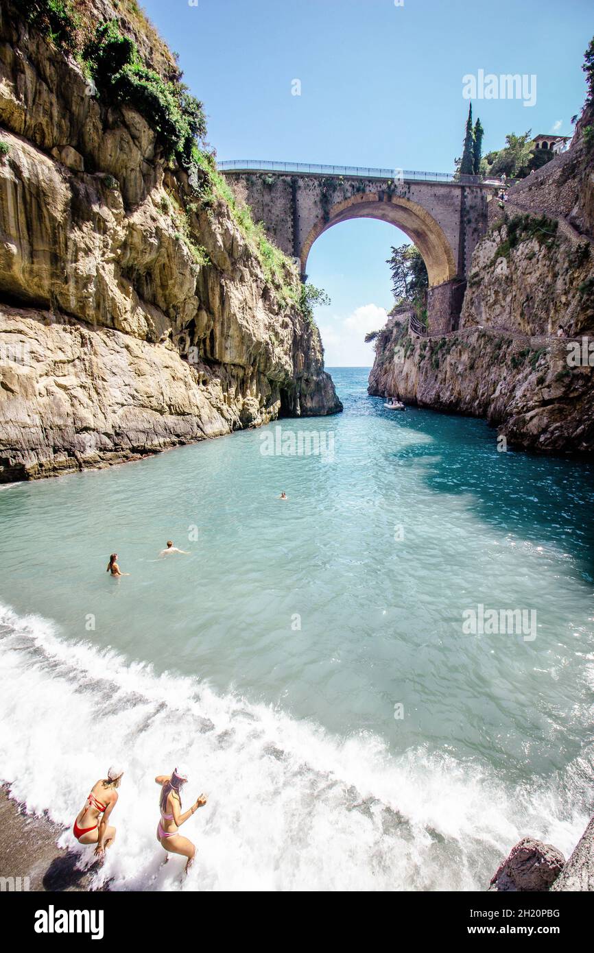 Fiordo di Furore is an arched stone bridge crosses this striking gorge with a tiny, rocky beach at its base. Stock Photo