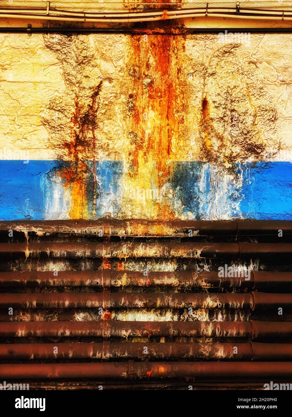 Bright, colorful, graphic color photograph of leaking and decaying pipes make beautiful patterns on the wall of the PATH train station in Hoboken, NJ, Stock Photo