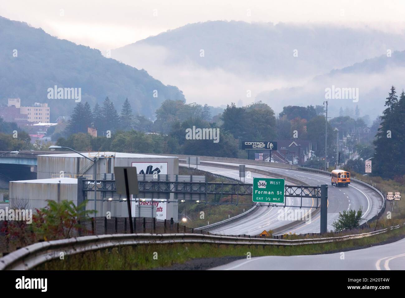 Bradford, Pennsylvania - An early morning school bus on US Highway 219 (the Pittsburgh-Buffalo Highway) in foggy weather. Bradford is located in a val Stock Photo