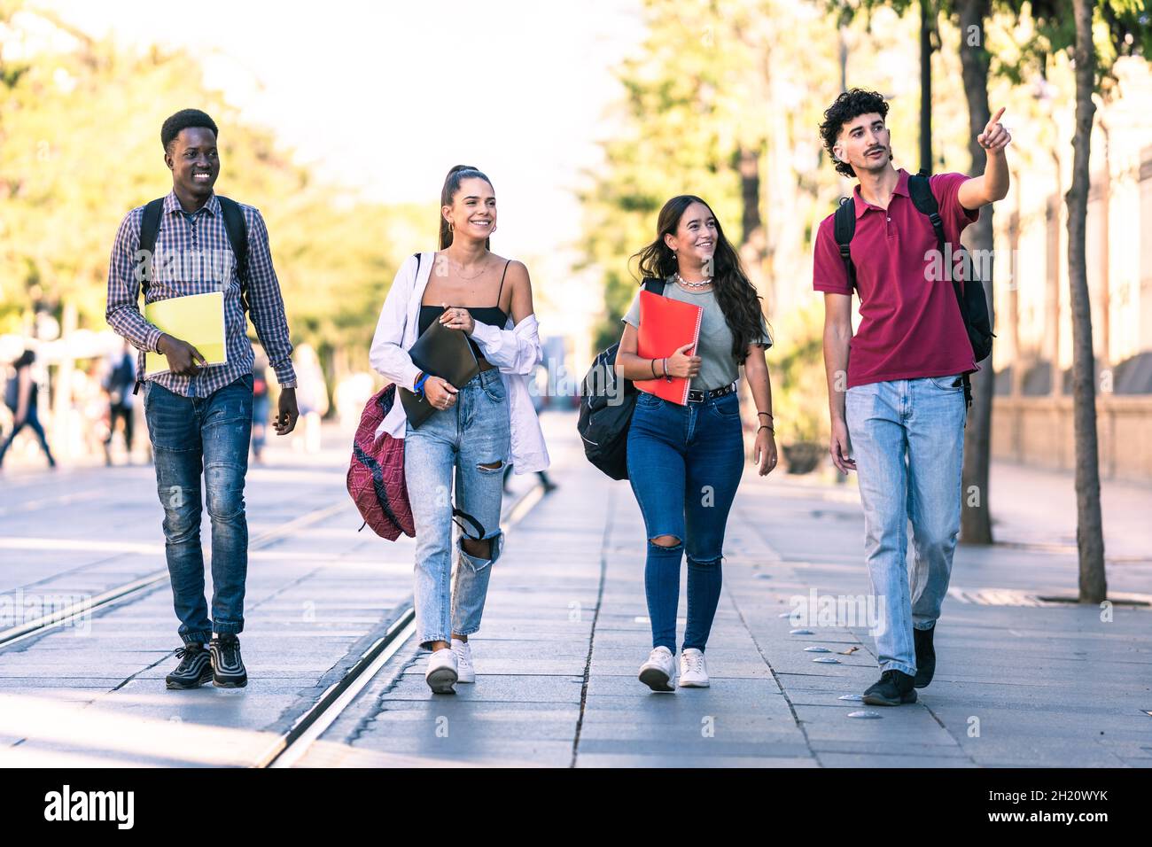 Group of students of different ethnicities walking in a pedestrian street Stock Photo