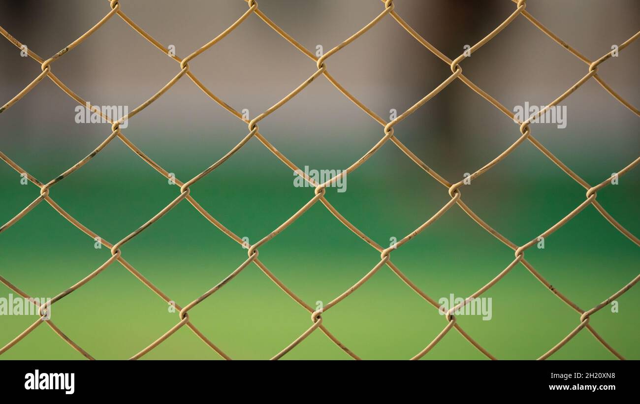 Close up of old chain fence at a football ground. Selective Focus Stock Photo