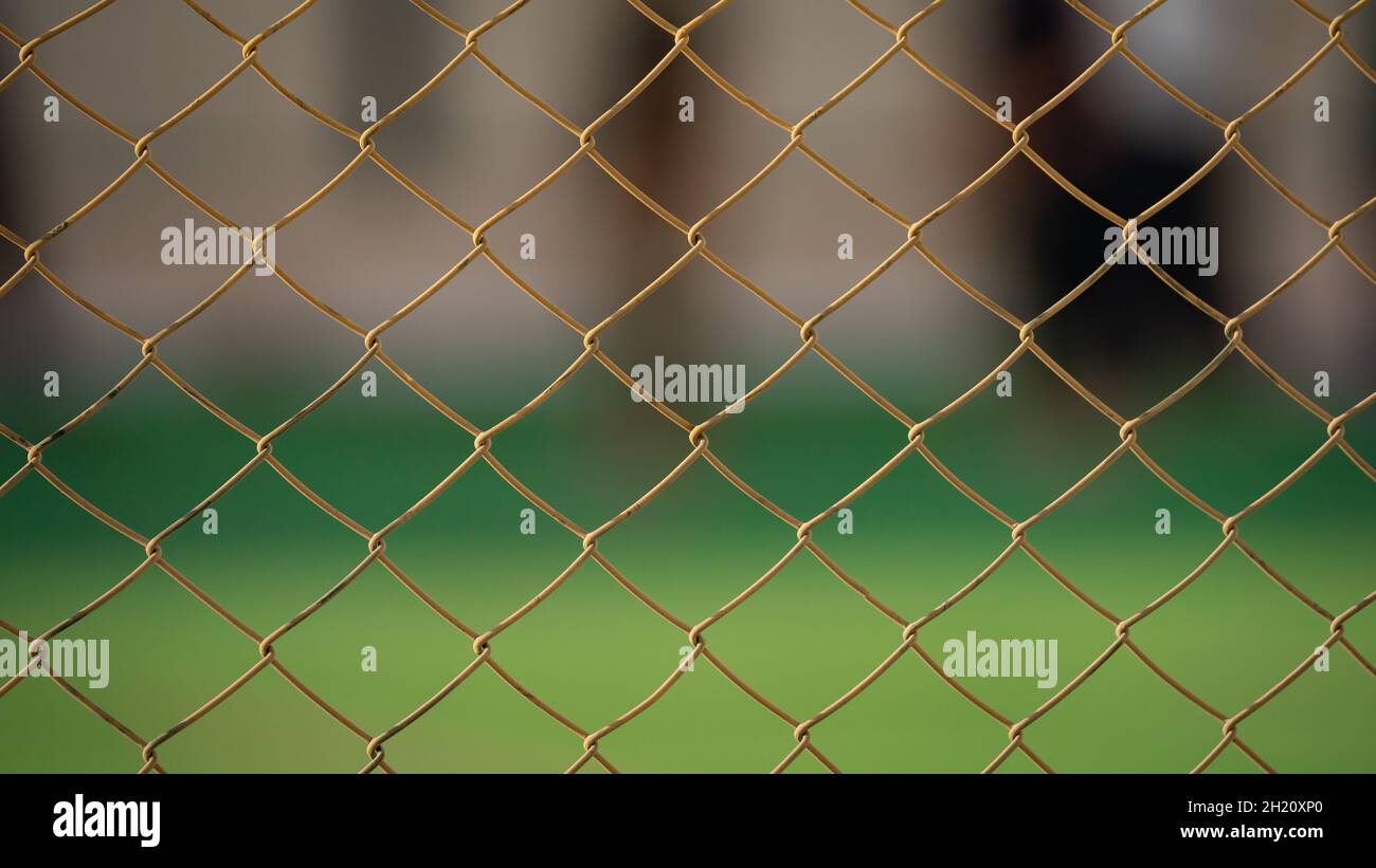 Close up of old chain fence at a football ground. Selective Focus Stock Photo
