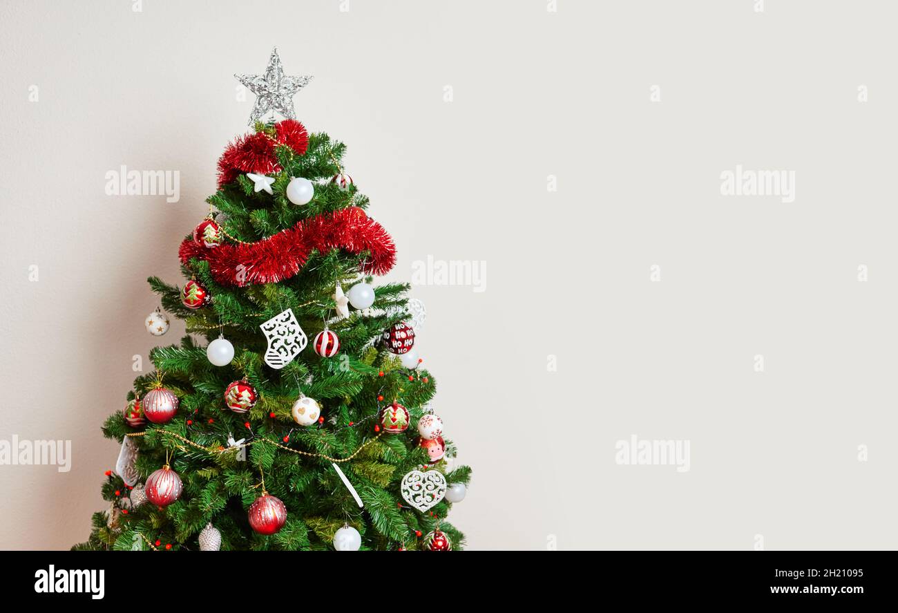 Big beautiful christmas tree decorated with beautiful shiny baubles Stock Photo