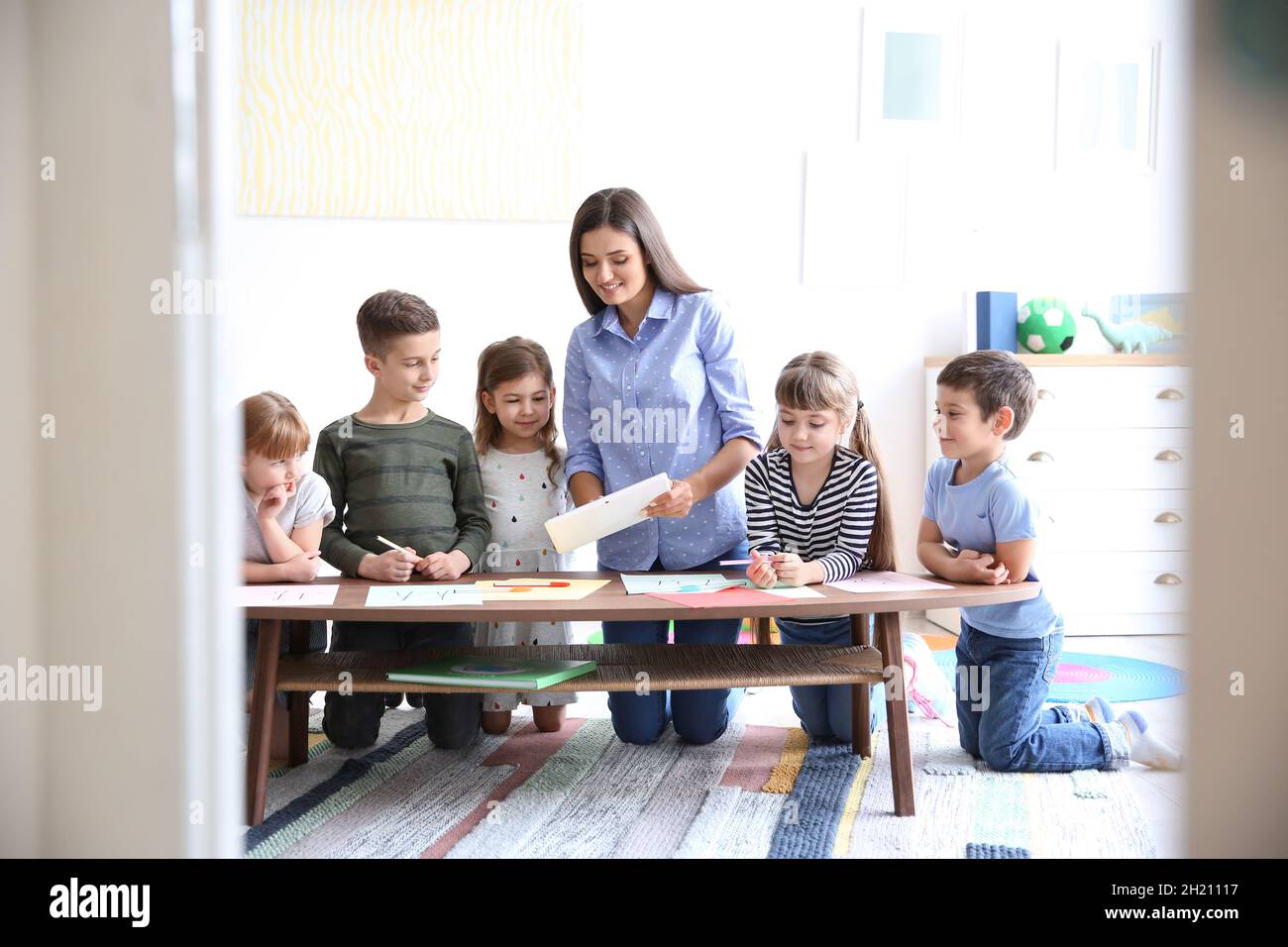 Cute little children with teacher in classroom at school Stock Photo ...