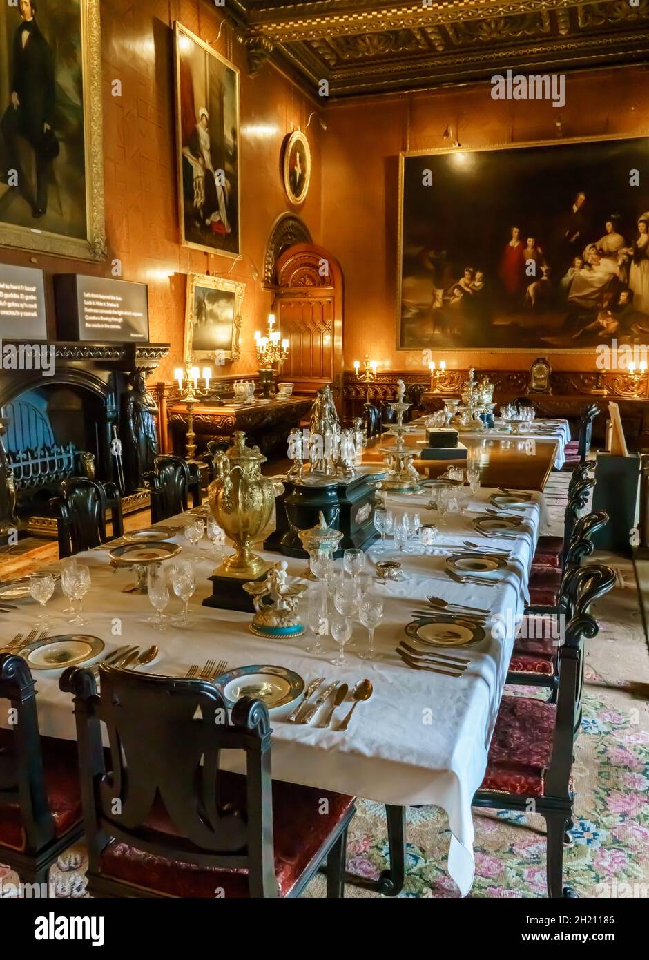 a lavish dining table and room at Penrhyn Castle, an extensive country house in Llandygai, Bangor, Wales UK Stock Photo