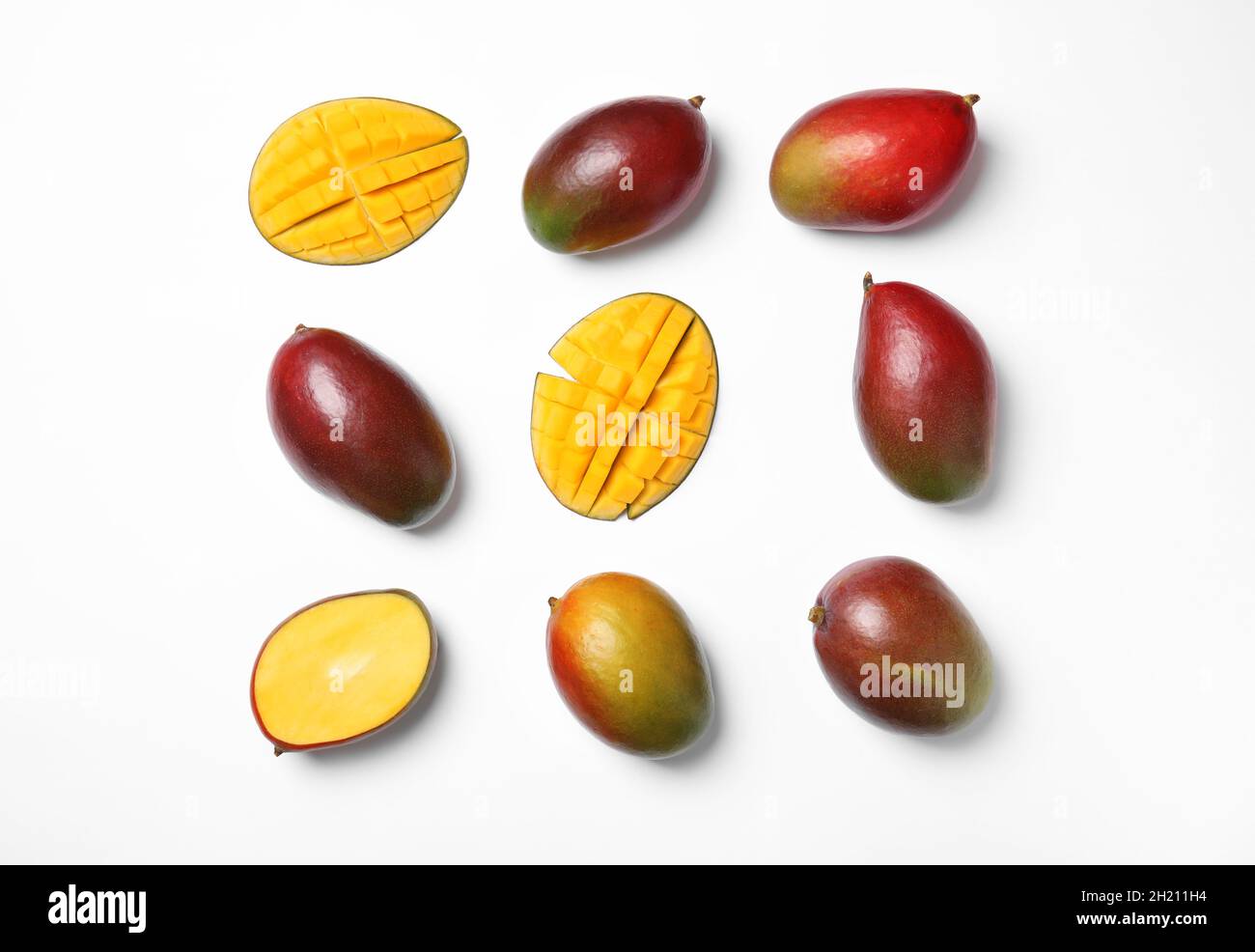 Tropical cut and whole mango fruits isolated on white, flat lay Stock ...