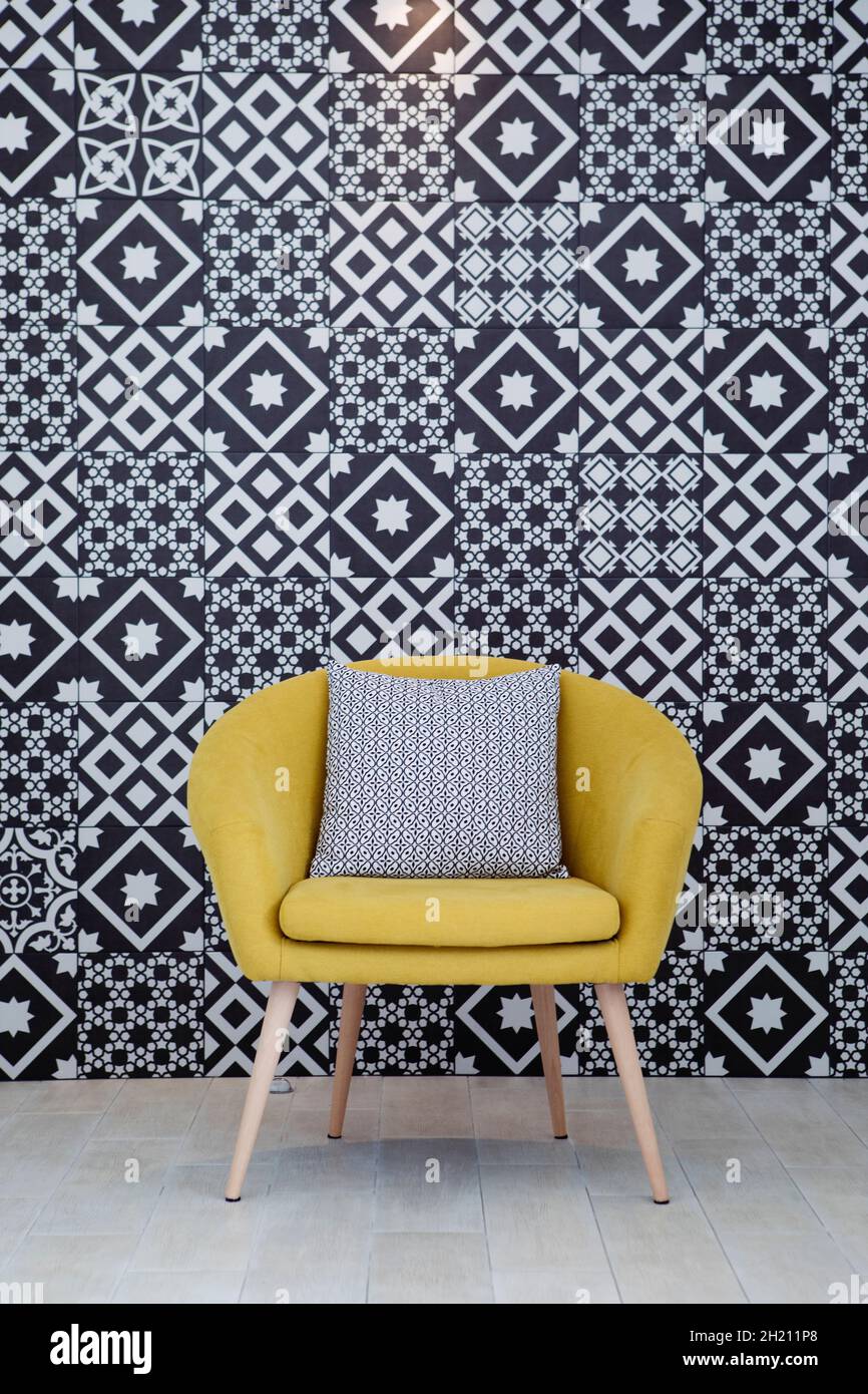 Yellow armchair before black and white background Stock Photo