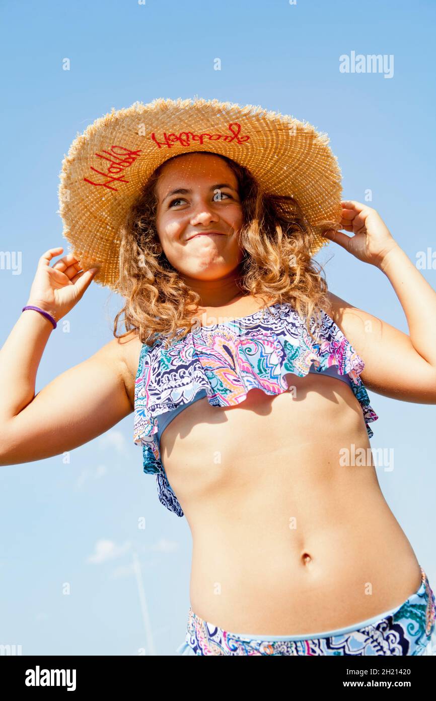 Young girl in bikini on vacation wearing a hut Stock Photo