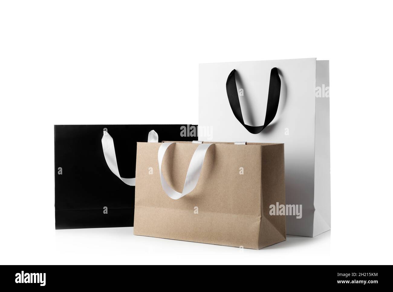 Paper shopping bags with ribbon handles on white background. Mockup for  design Stock Photo - Alamy