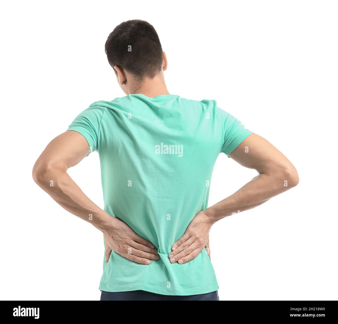 Young man suffering from back pain on white background Stock Photo - Alamy