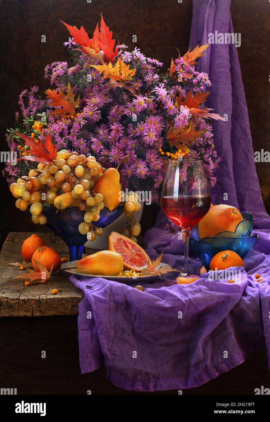 Still life with red wine, fruits and a bouquet of flowers Stock Photo ...