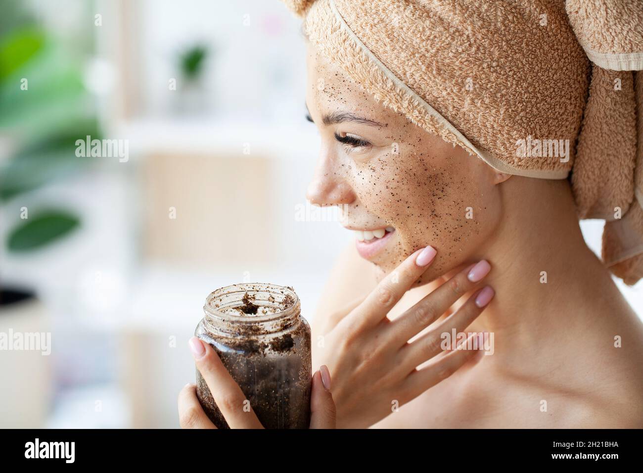 Young beautiful girl applying facial scrub mask on skin Stock Photo Alamy