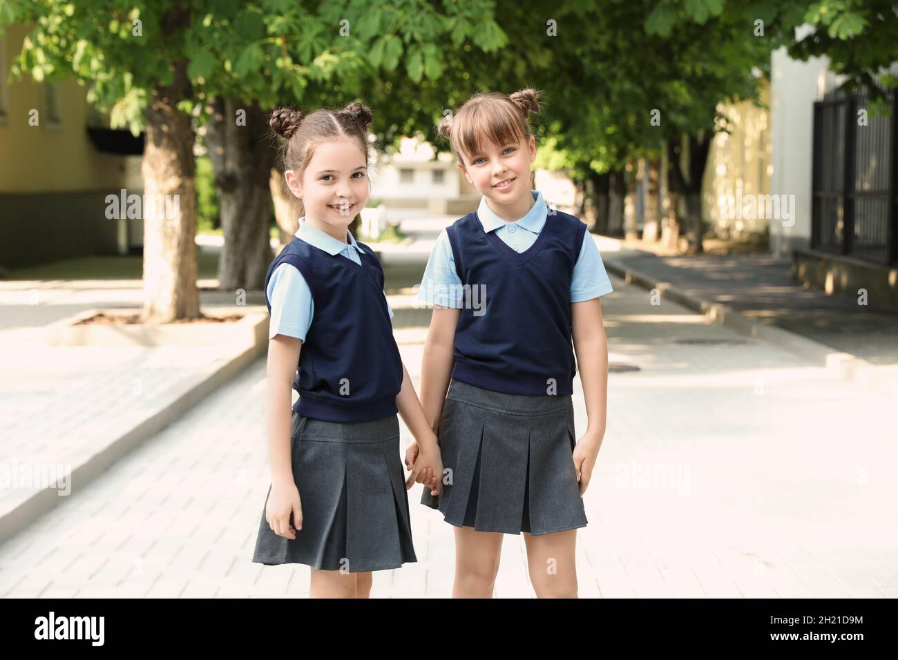 Little girls in stylish school uniform outdoors Stock Photo - Alamy