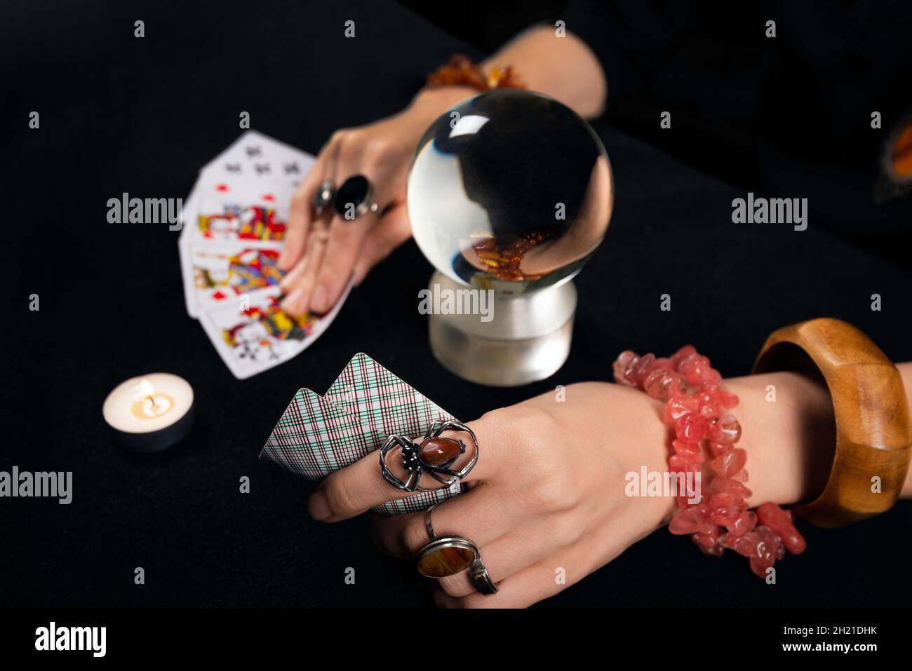 Fortune teller or witch hands, cards, candles and magic ball. Halloween