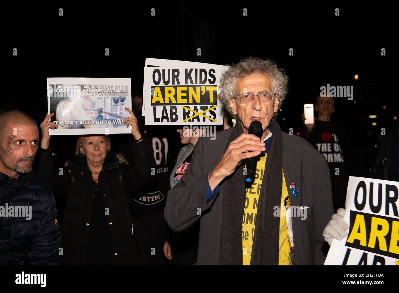 Westminster, UK. Controversial activist and Anti-Vaxxer Piers Corbyn who is the brother of Labour Party MP, Jeremy Corbyn, was outside the House of Commons this evening with a group of his anti-vax followers some of whom were holding up Our Kids Aren't Lab Rats posters. Piers Corbyn was inviting people to come and burn effigies of Boris Johnson and others on 5th November in London. His followers were also challenging members of the public who were wearing face masks Stock Photo