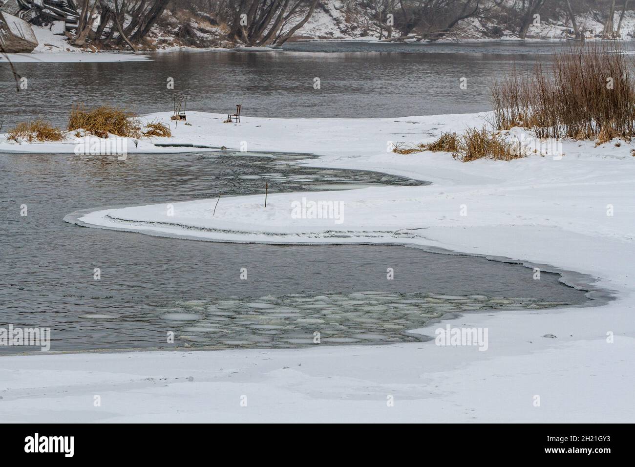 Winter landscape with a partially frozen river and snowy shore Stock ...
