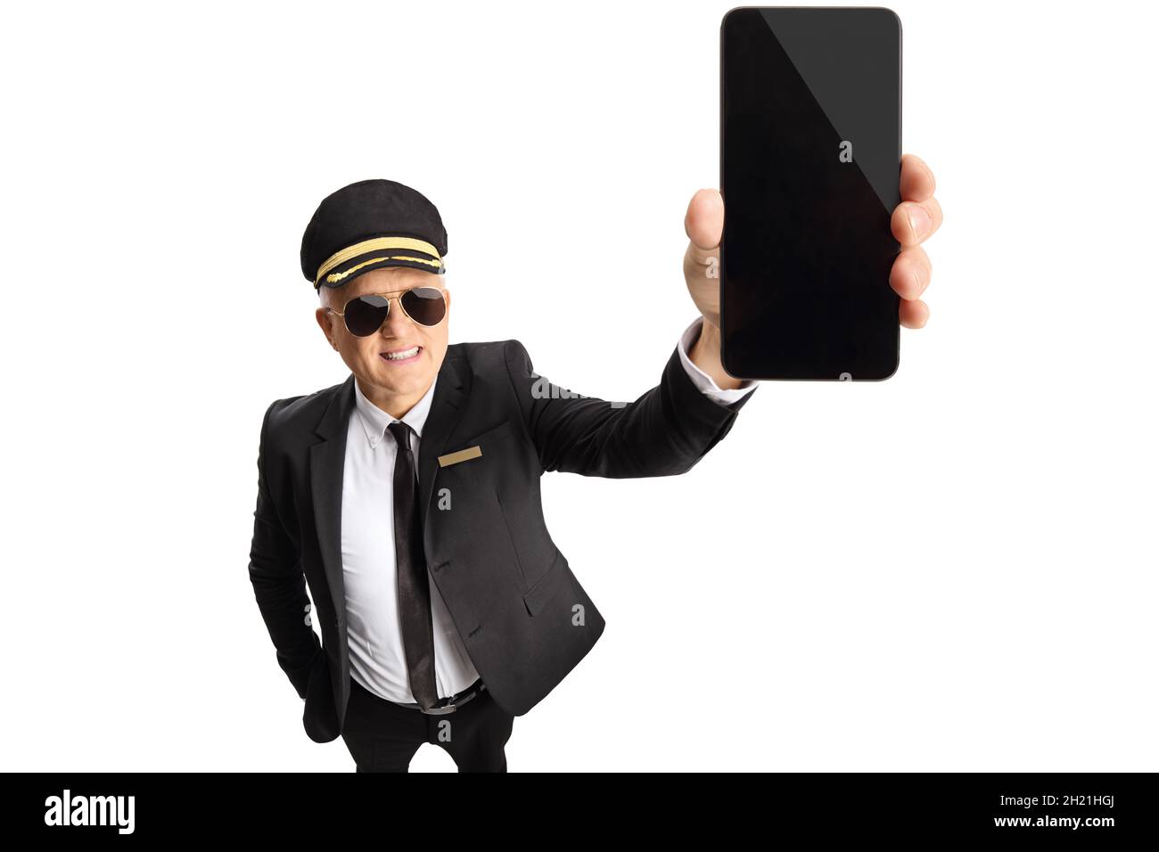 Mature chauffeur showing a smartphone in front of camera isolated on white background Stock Photo