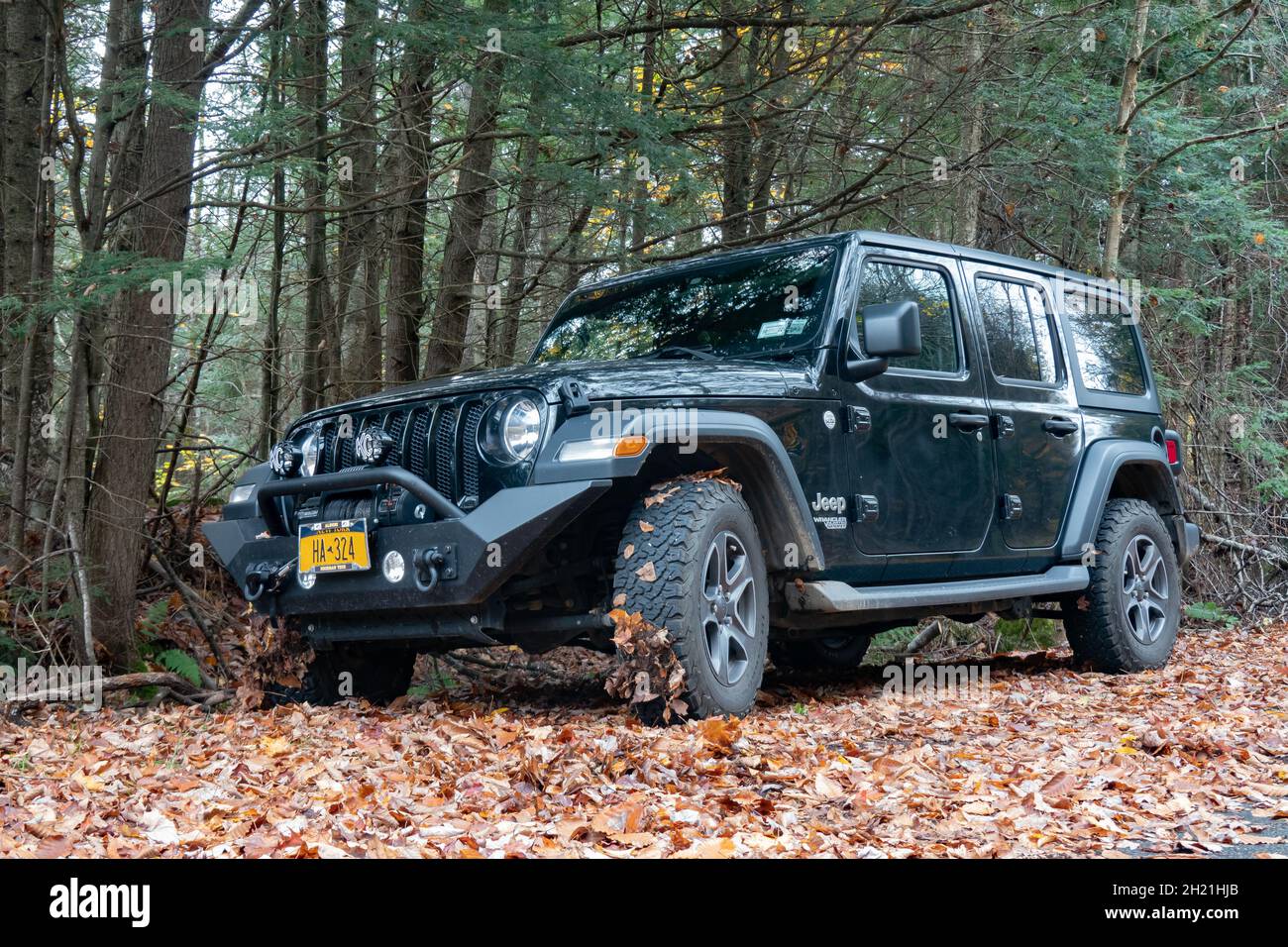 A black Jeep Wrangler Unlimited JL with a custom steel bumper, winch
