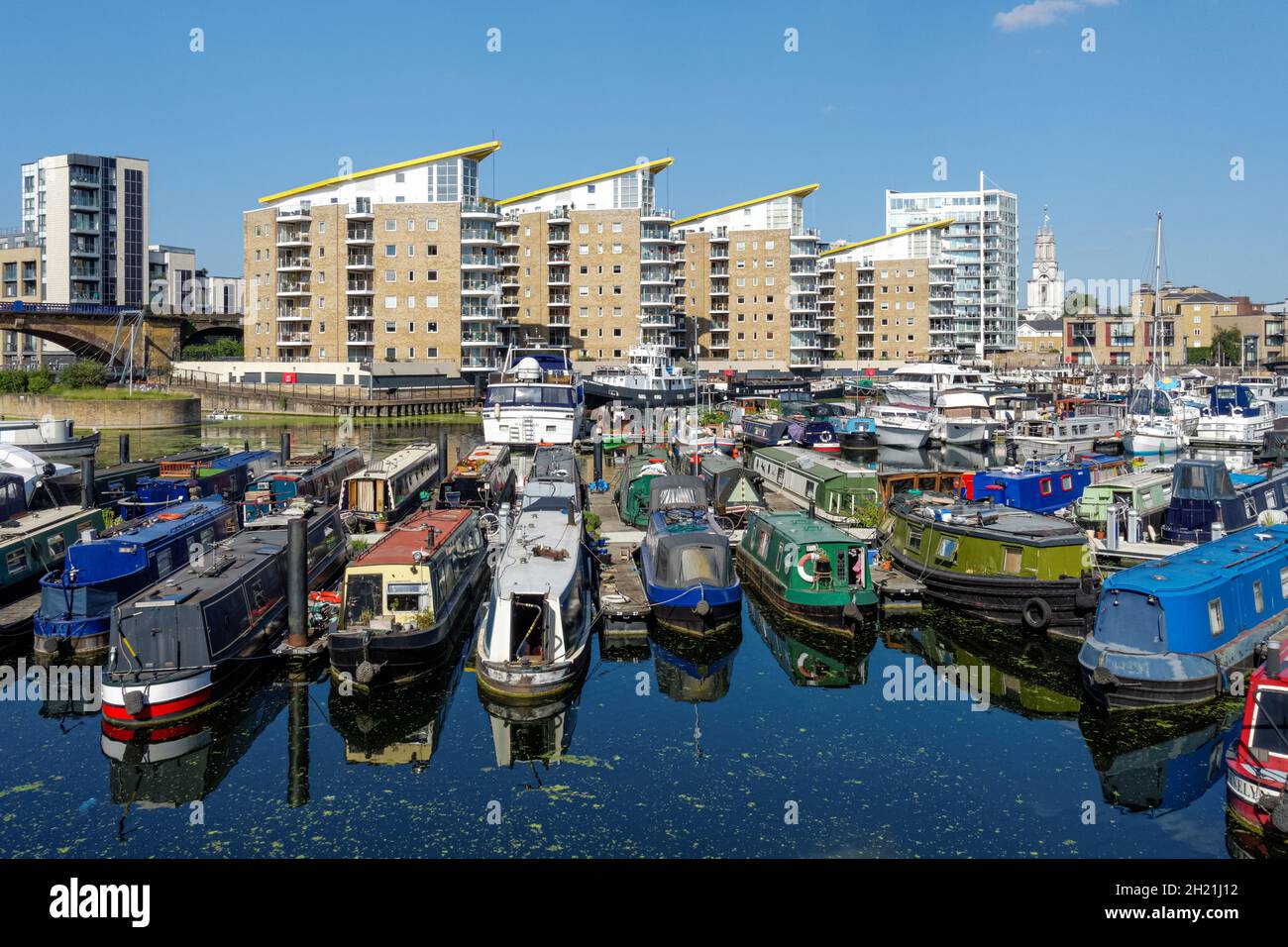 Houseboats at Limehouse Basin with Marina Heights, modern residential buildings in the background, London, England United Kingdom UK Stock Photo