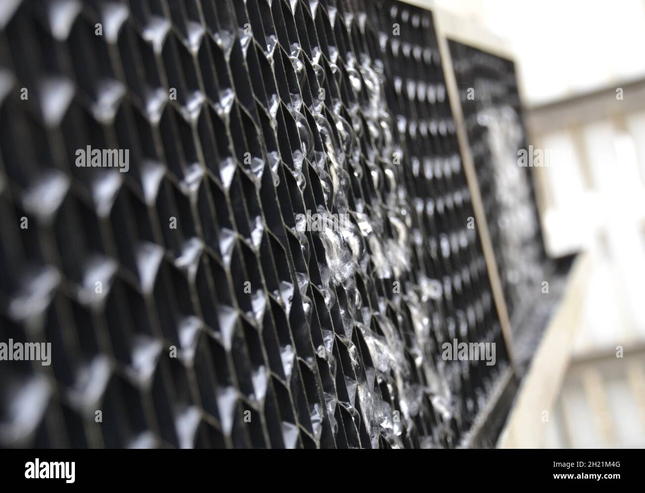 Closeup view of water leaking from the air intake louvers on an air