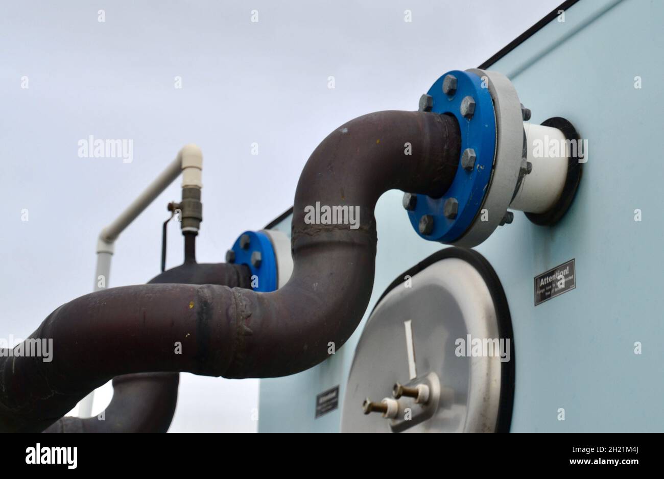 Cooling water pipes and flanges on an HVAC rooftop cooling tower and