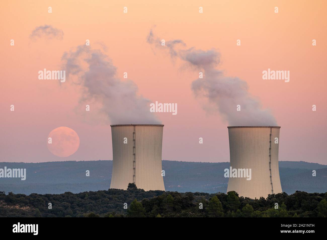 Trillo, Spain. 19th Oct, 2021. An almost full moon of October, known as Hunter's Moon, rises over the cooling towers of the Trillo Nuclear Power Plant. Credit: Marcos del Mazo/Alamy Live News Stock Photo