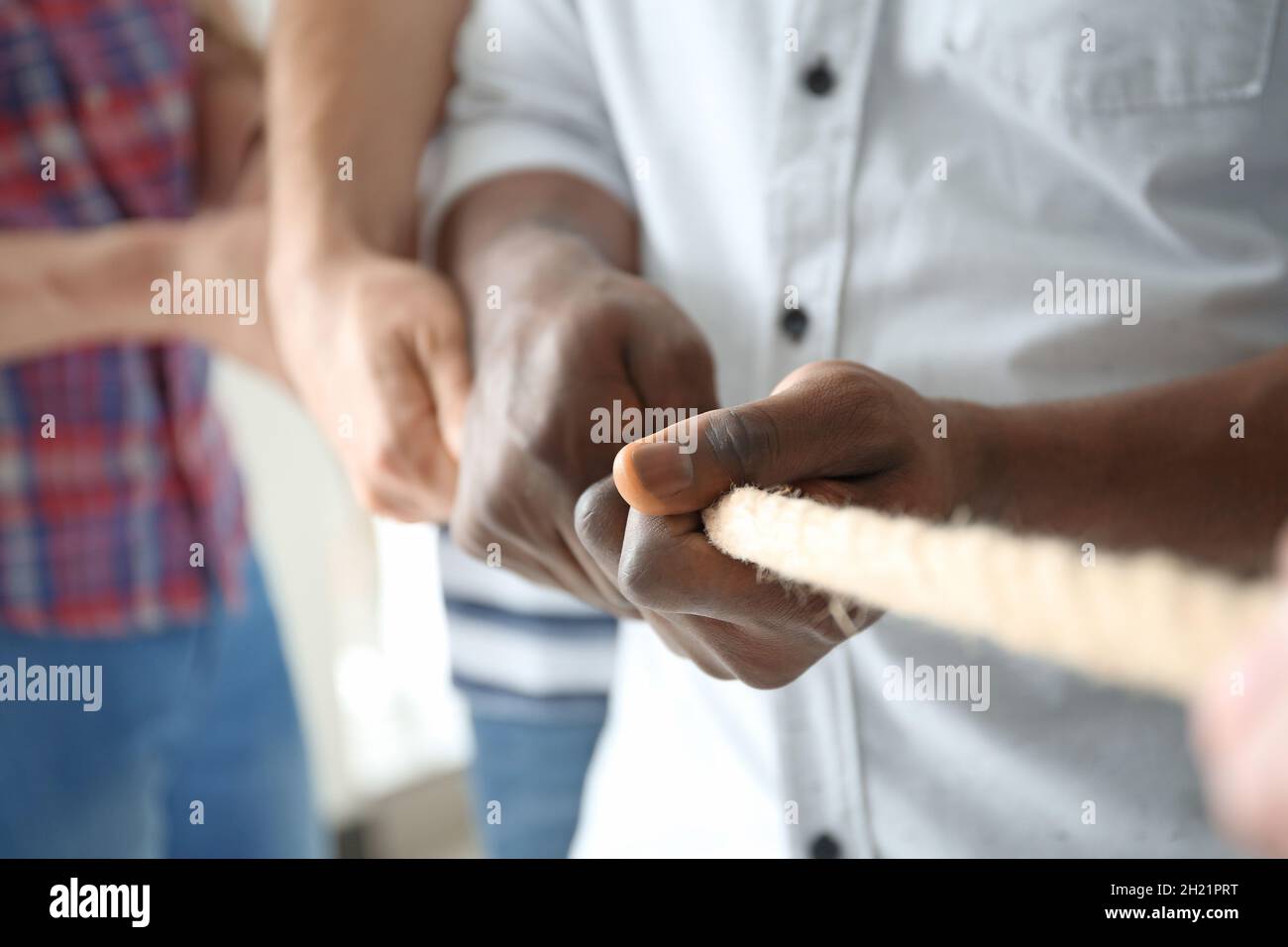 People pulling rope together, closeup of hands. Unity concept Stock ...