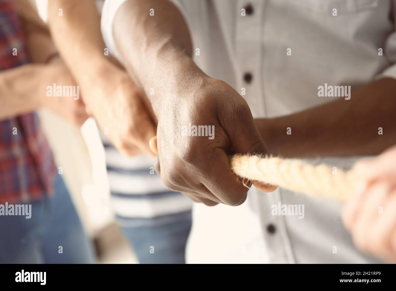 People pulling rope together, closeup of hands. Unity concept Stock ...