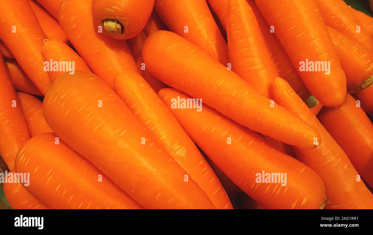 Many carrots are placed together in the shop for sale. Stock Photo