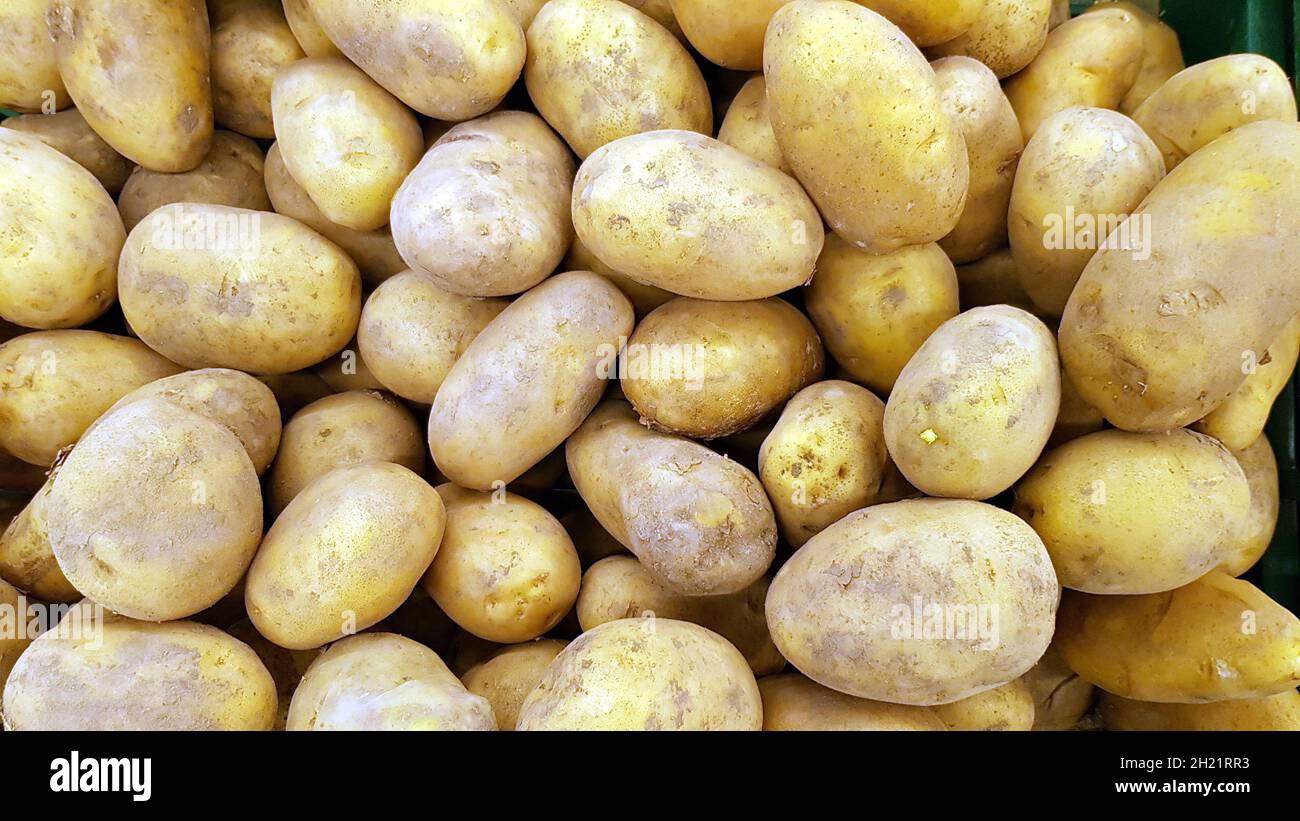 Potatoes are placed in shelves for sale. Stock Photo