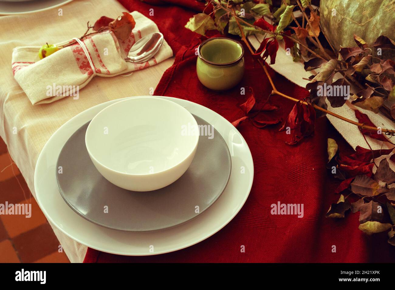 Stylish thanksgiving autumn table decor with pumpkin and dried branches Stock Photo