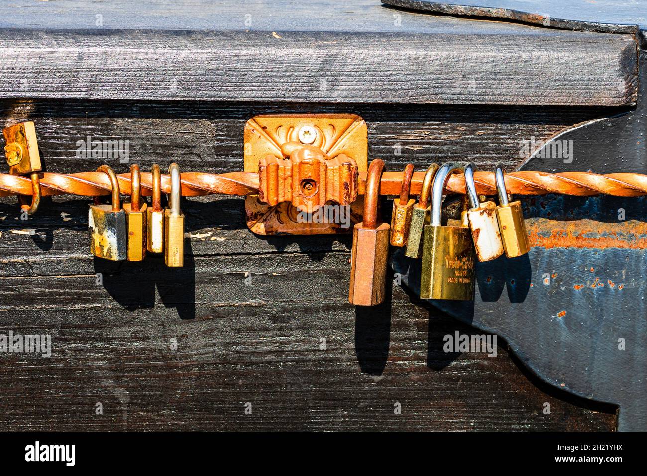 BUCHAREST, ROMANIA - Sep 01, 2021: A love symbol, old rusty padlocks hanging on wooden fortress bridge in Alba Iulia, Romania Stock Photo