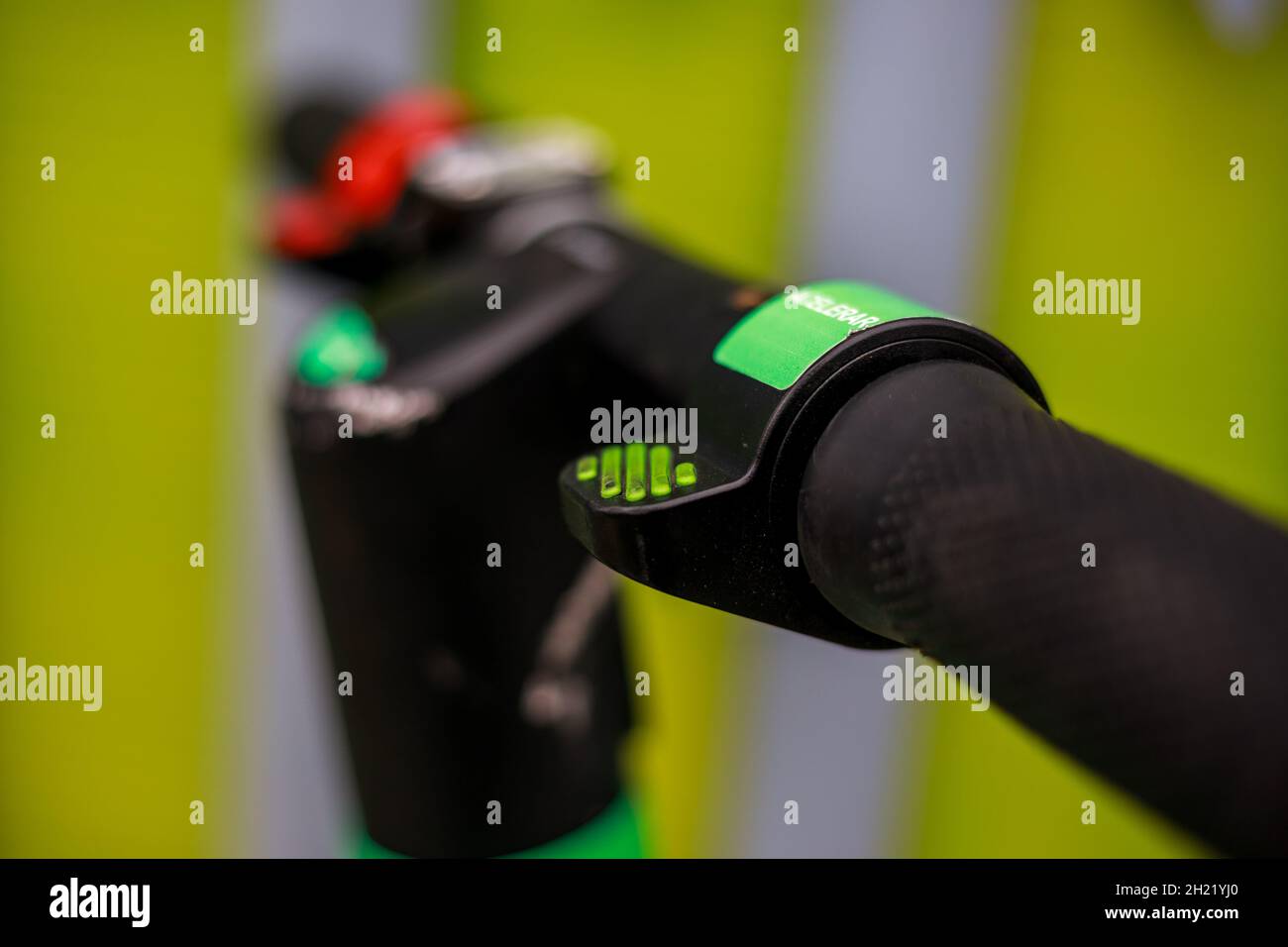 A close up of an electrical scooter handlebar steering acceleration button. Stock Photo