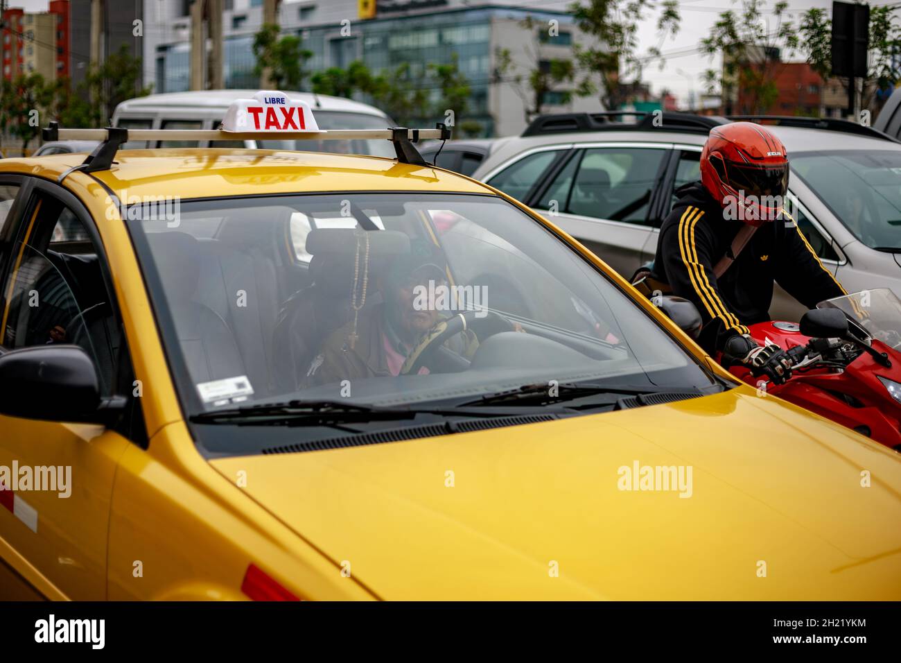 Lima, Peru - 12.09.2019: Peruvian adult man cab driver looking to the camera thru his cab windscreen Stock Photo