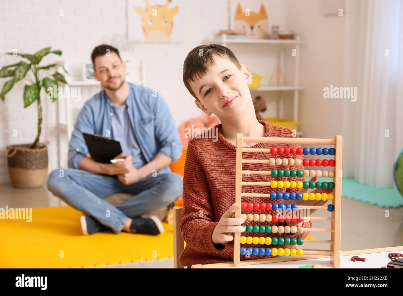 Little boy with autism spectrum disorder at psychologist's office Stock