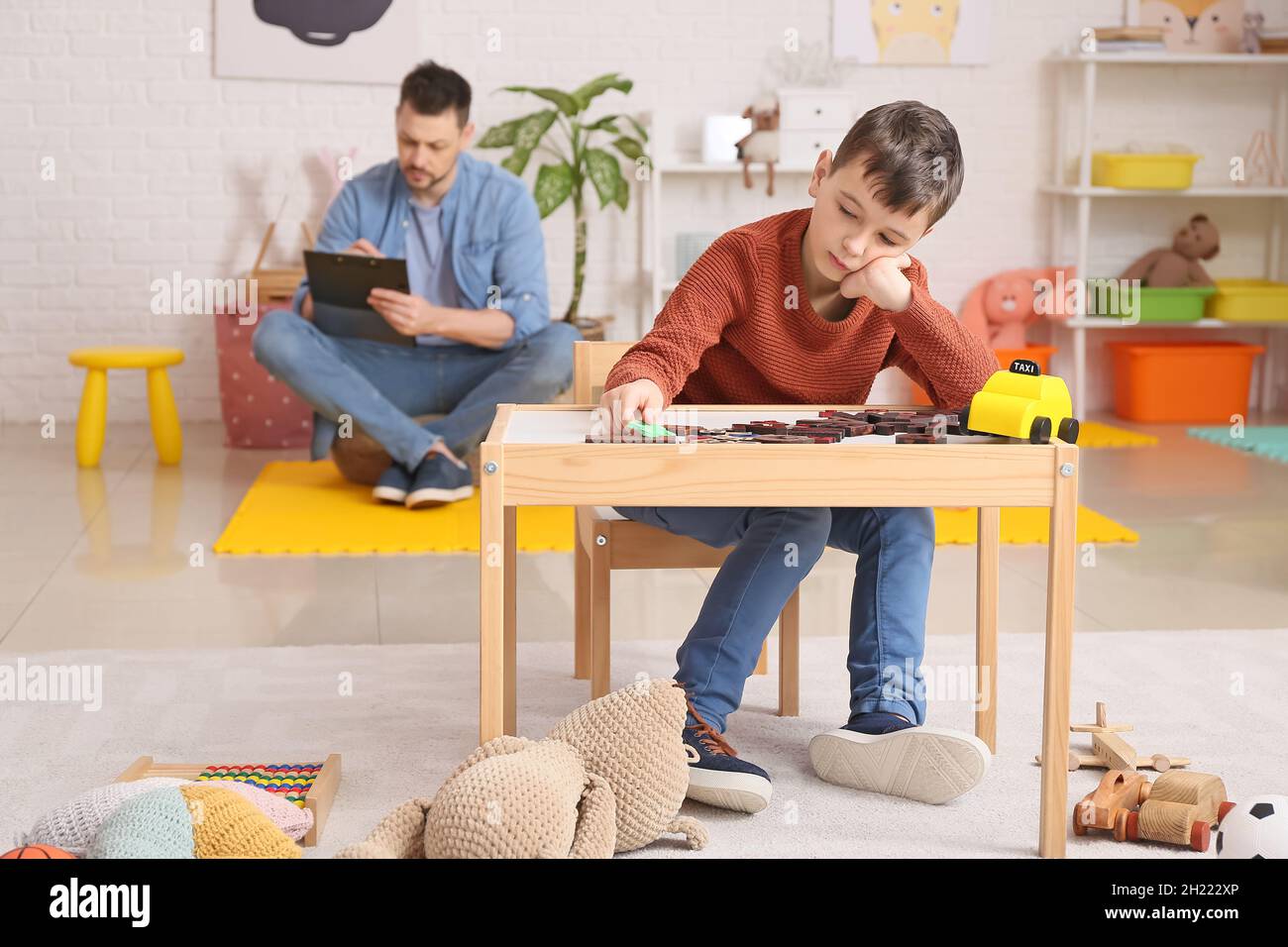 Little boy with autism spectrum disorder at psychologist's office Stock