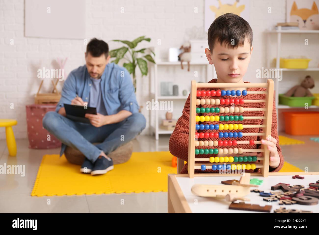 Little boy with autism spectrum disorder at psychologist's office Stock