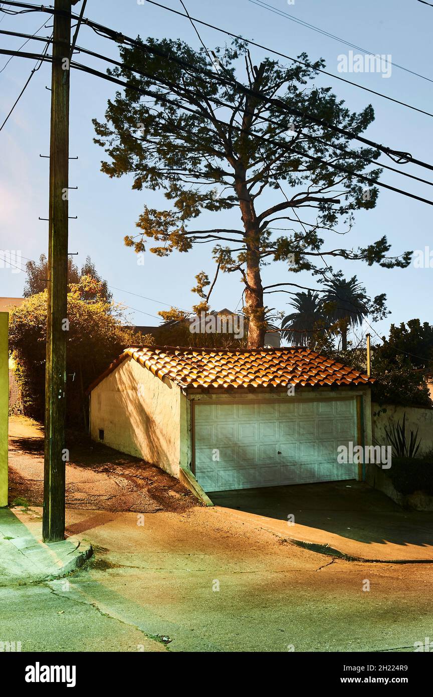 Garage on empty street in Silver Lake, Los Angeles in evening lit by street lights. Stock Photo