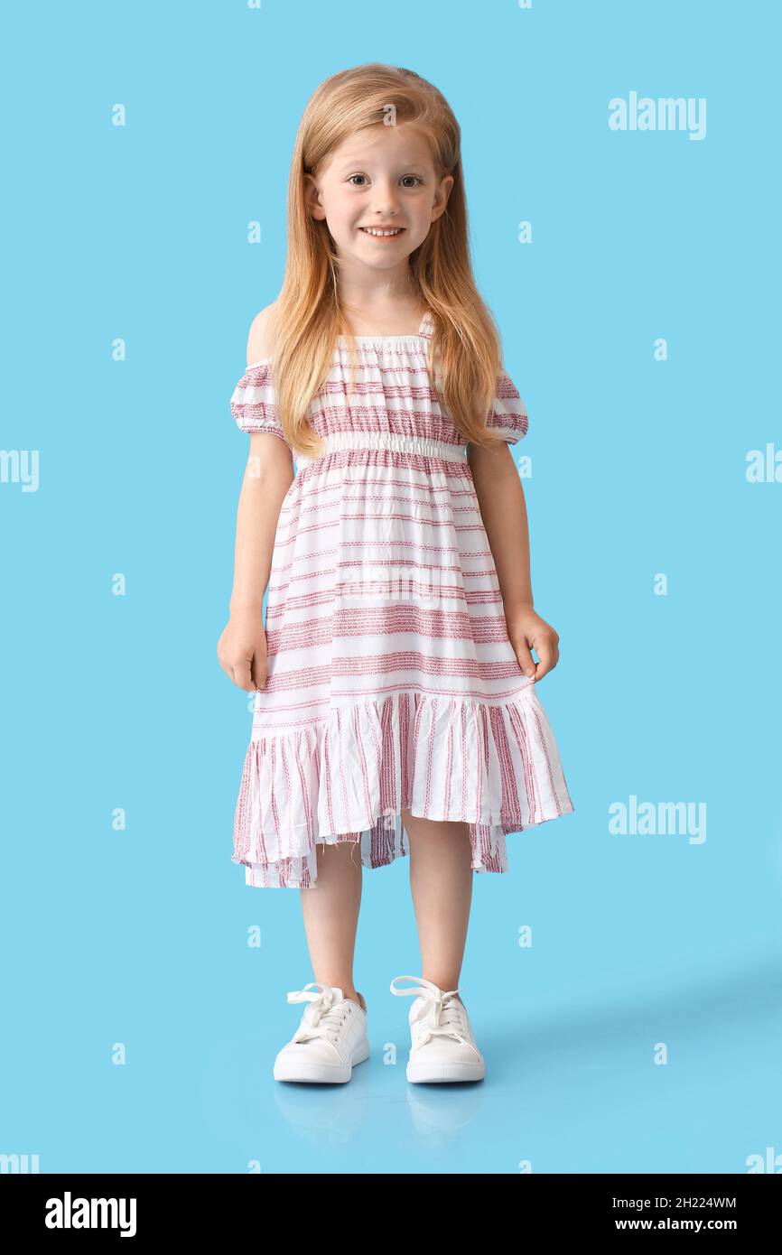 Little girl in cute dress on blue background Stock Photo - Alamy