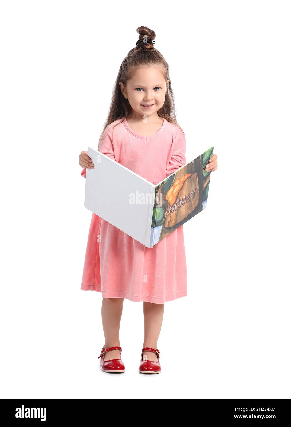 Adorable little girl reading book on white background Stock Photo - Alamy