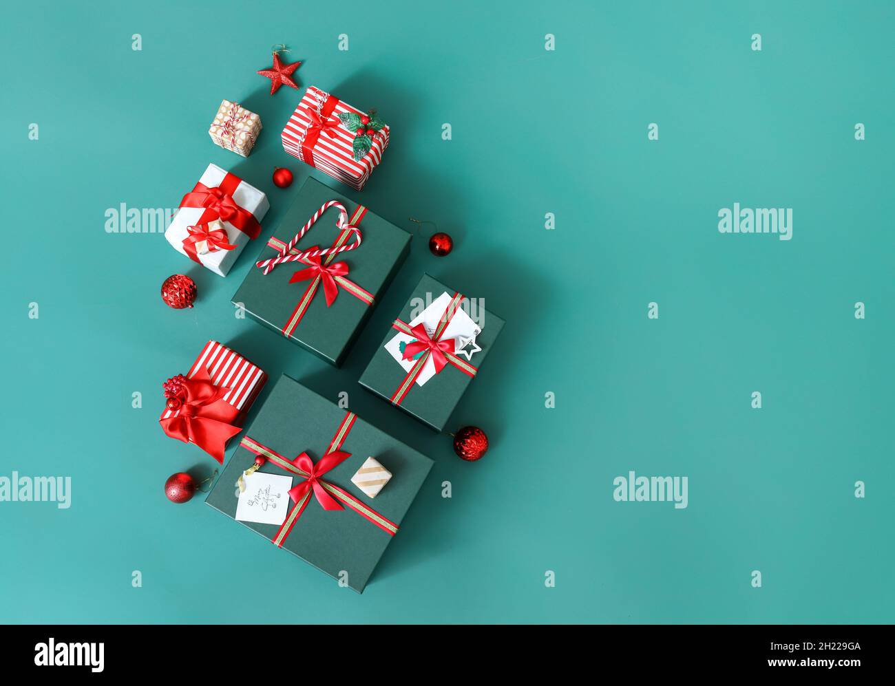 Christmas tree made of gift boxes and balls on green background Stock ...