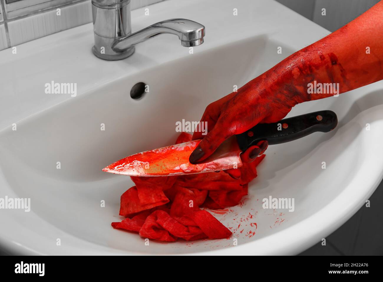 Maniac washing blood off hands and knife in sink Stock Photo - Alamy