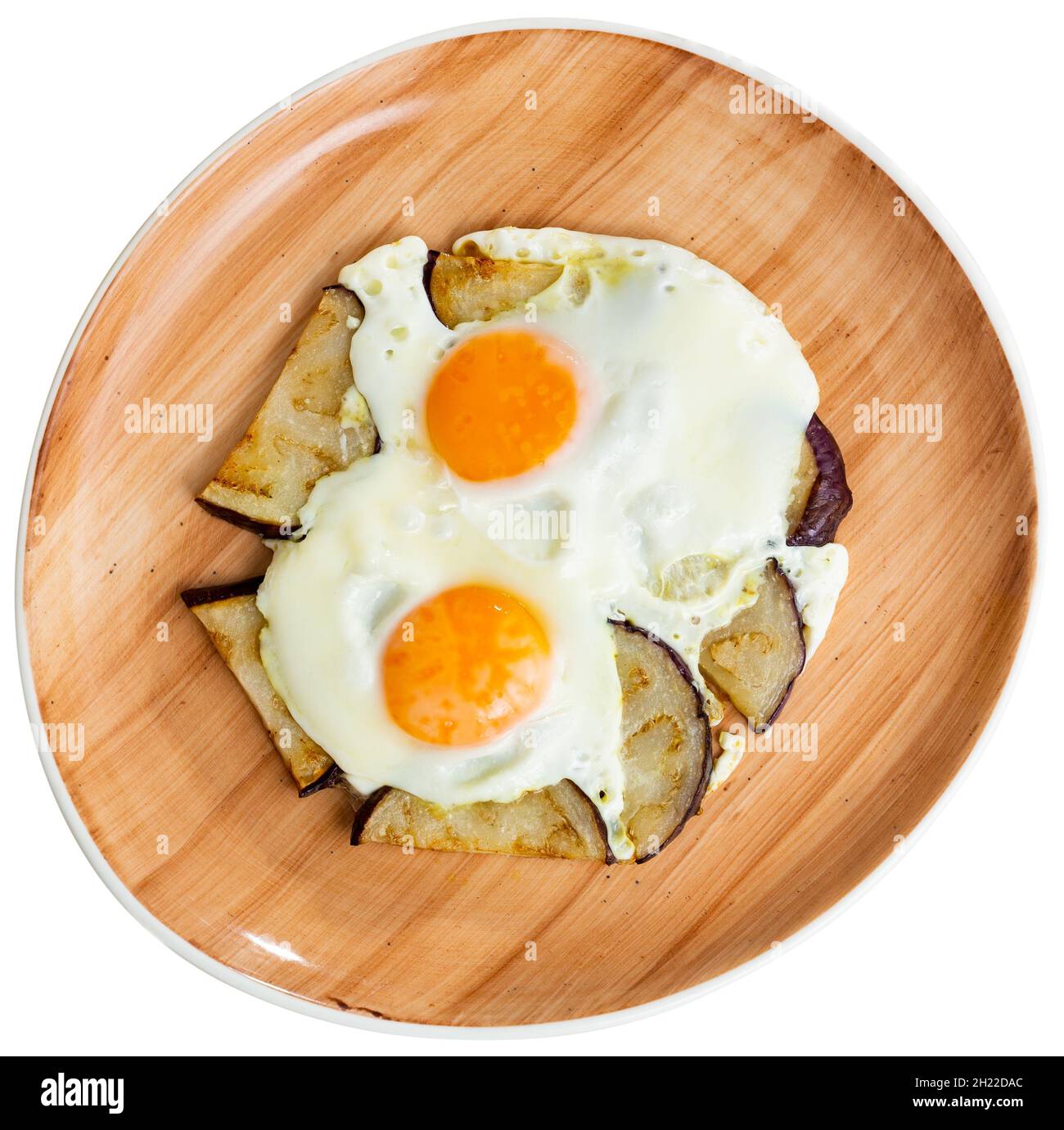 Delicious breakfast scrambled eggs with fried eggplant closeup Stock